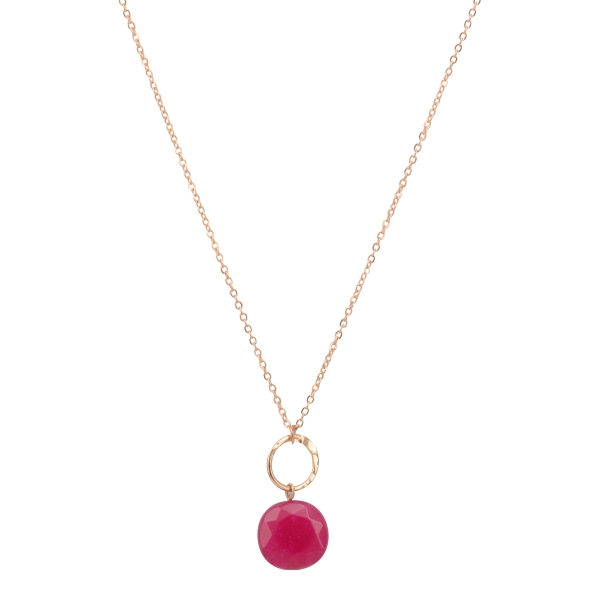 Gold tone necklace featuring a hammered ring with a hanging fuchsia natural stone. Approximately 16" in length.