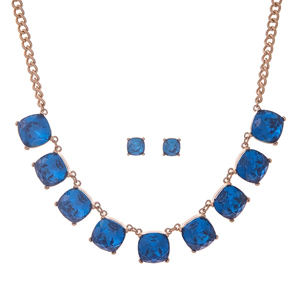 Gold tone necklace set with blue cabochons. Approximately 17" in length.