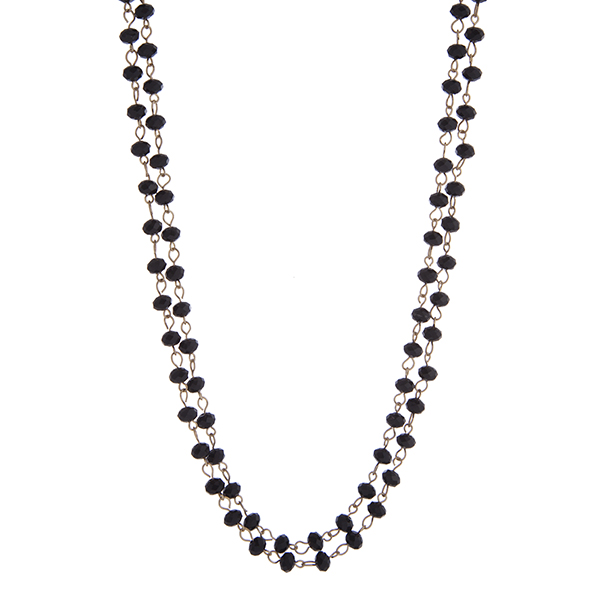 Gold tone black beaded wrap necklace. Approximately 60" in length. 
