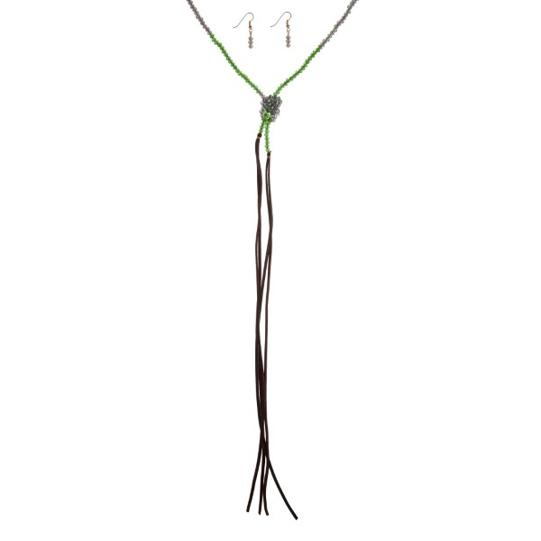 Green beaded open lariat wrap necklace with faux leather tassels. Approximately 70" in length. 