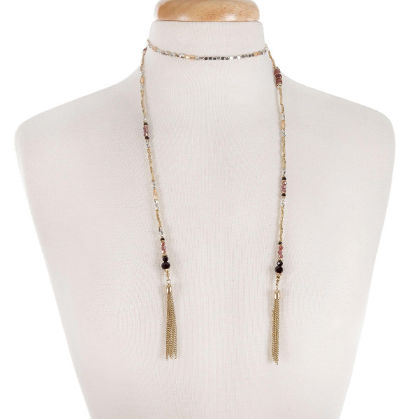 Two tone lariat necklace with black and burgundy beads, and chain tassels. 
