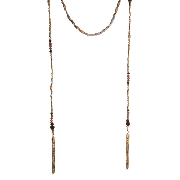 Two tone lariat necklace with black and burgundy beads, and chain tassels. 