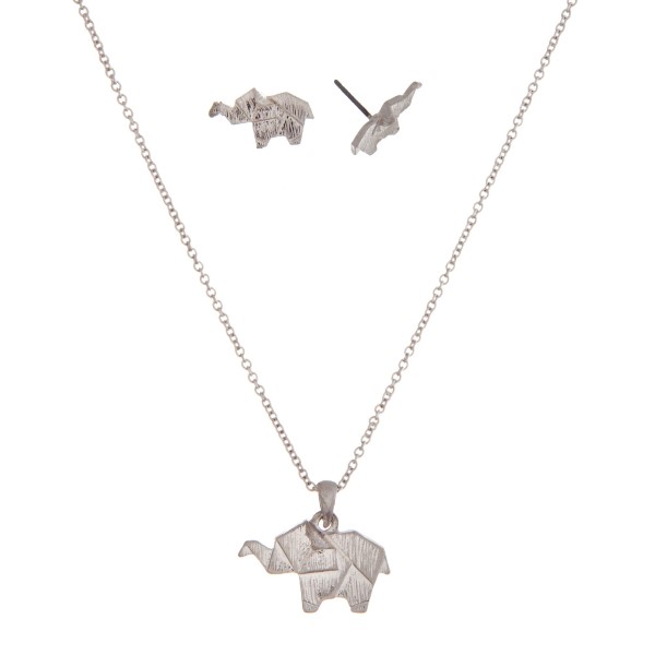 Dainty silver tone necklace with an origami elephant pendant. Approximately 16" in length. 