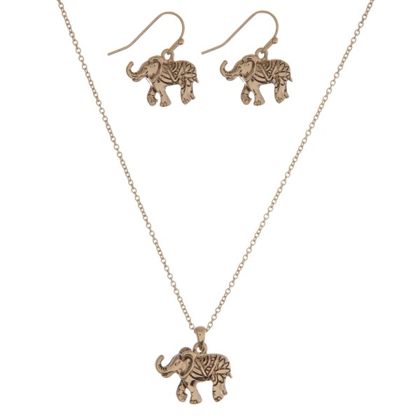 Dainty gold tone necklace set with an elephant pendant and matching fishhook earrings. Approximately 16" in length. 
