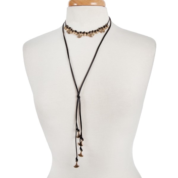 Black cord double layer choker necklace with gold tone charms. Approximately 32" in length.