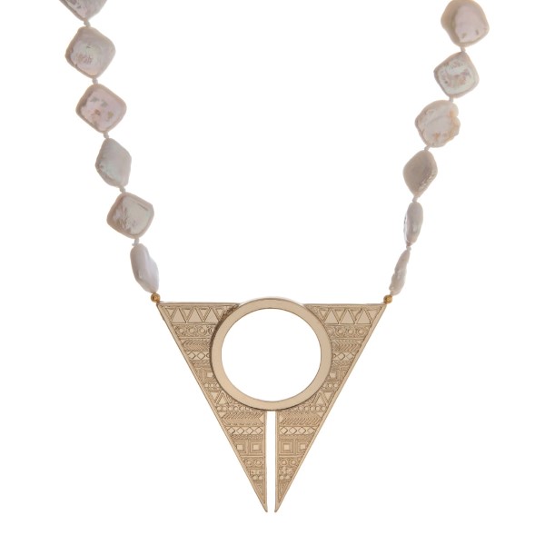 Gold tone necklace with freshwater pearls and a stamped geometric pendant. Approximately 16" in length. Handmade in the USA. 