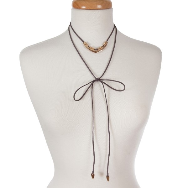 Gray suede wrap necklace with an adjustable short layer displaying a hammered silver tone triangle and arrowheads on the long ends. Can be adjusted to any length up to 36 inches. 