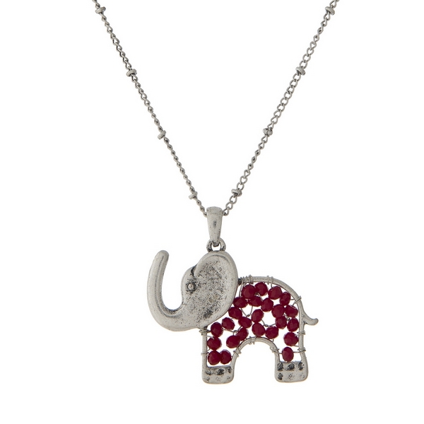 Silver tone necklace with a crimson beaded elephant pendant. Approximately 30" in length. 