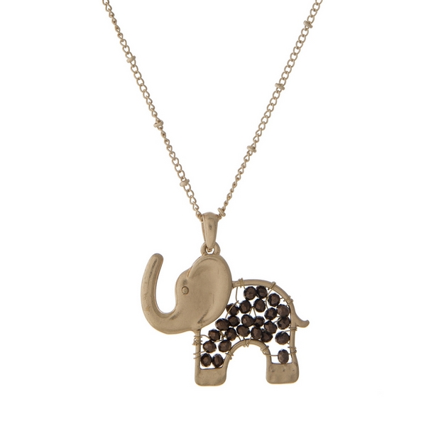 Gold tone necklace with a bronze beaded elephant pendant. Approximately 30" in length. 