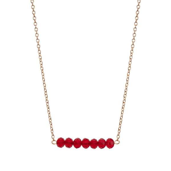 Gold tone beaded bar necklace with crimson faceted beads. Approximately 16" in length. 