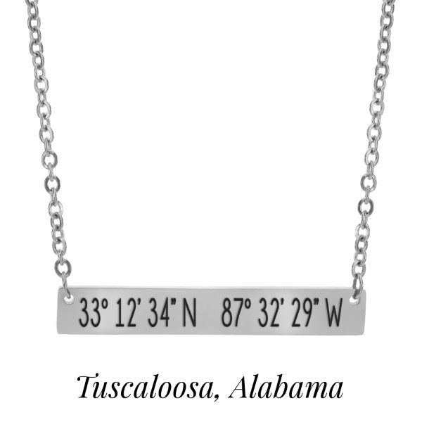 Silver tone necklace with a bar pendant stamped with the coordinates of Tuscaloosa, Alabama. Approximately 18" in length. 