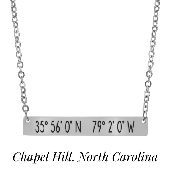 Silver tone necklace with a bar pendant stamped with the coordinates of Chapel Hill, North Carolina. Approximately 18" in length. 