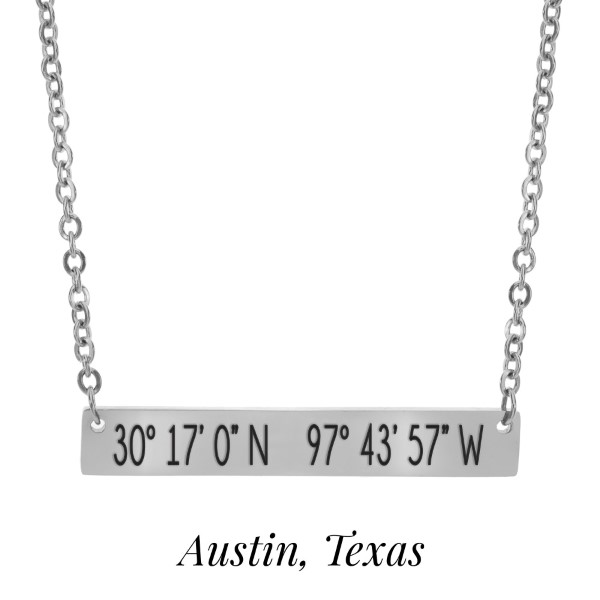 Silver tone necklace with a bar pendant stamped with the coordinates of Austin, Texas. Approximately 18" in length. 