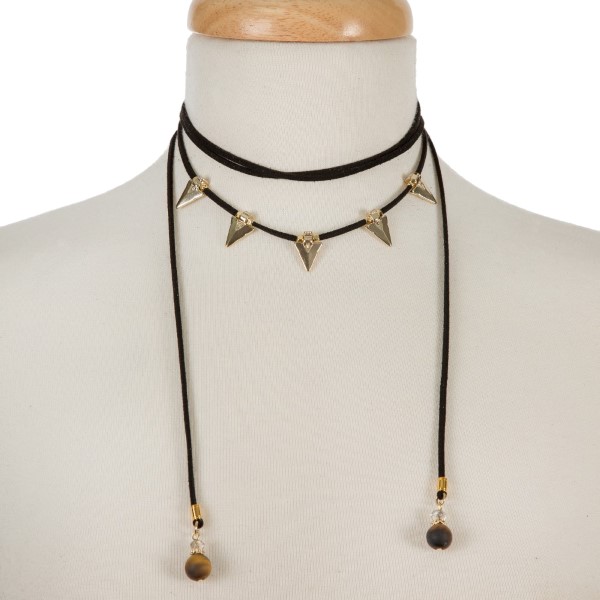 Black suede cord choker necklace with gold tone arrowheads and tiger's eye beads. Adjustable in length. Handmade in the USA. 