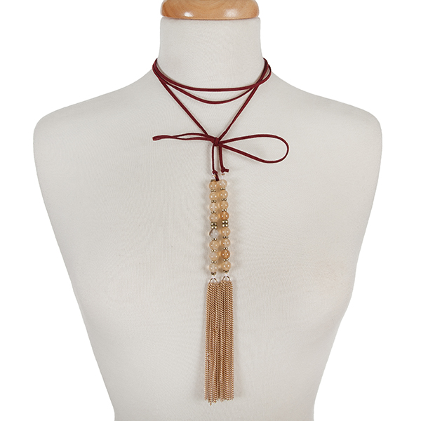 Burgundy faux suede wrap choker with beige natural stone beads and gold tone chain tassels. Approximately 12" in length. 