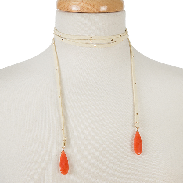 Tan faux suede wrap necklace with gold tone studs and coral stones on the ends. Approximately 64" in length. 