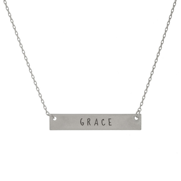 Matte silver tone bar necklace stamped with "Grace." Approximately 14" in length. 