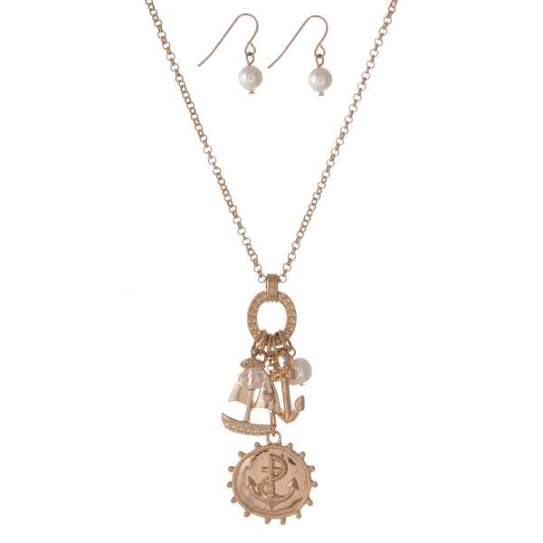 Gold tone necklace set with anchor and sailboat charms and matching fishhook earrings. Approximately 18" in length. 
