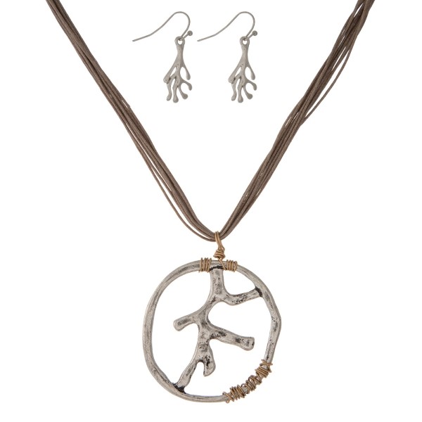 Gray cord necklace set with a silver tone coral reef pendant. Approximately 16" in length. 