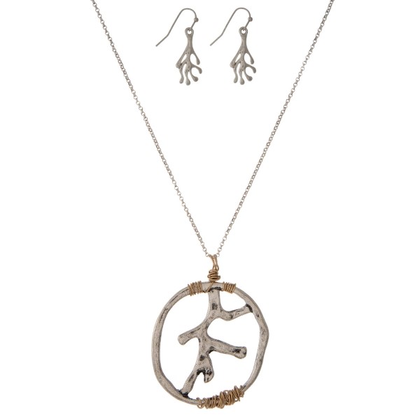 Silver tone necklace set with a coral reef pendant and matching fishhook earrings. Approximately 32" in length. 