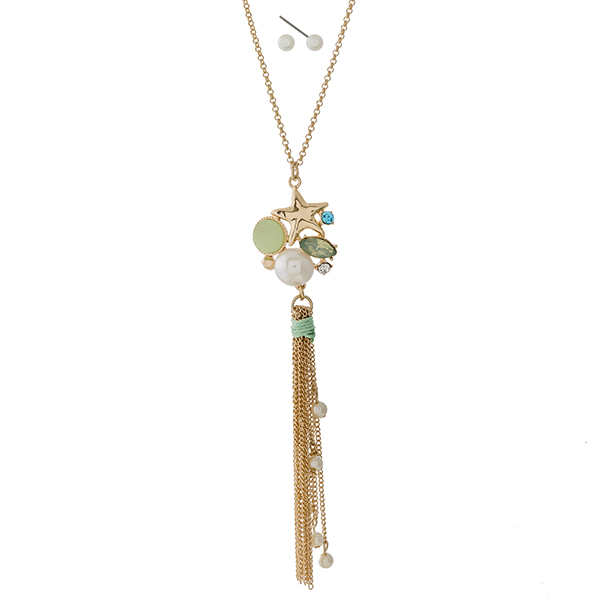 Gold tone necklace set with a seashell, mint green rhinestone, and tassel pendant. Approximately 22" in length. 