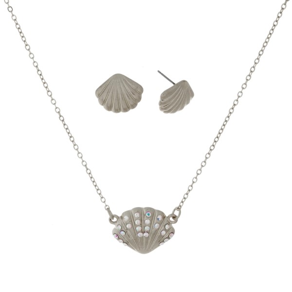 Dainty necklace set with a seashell pendant and matching stud earrings. Approximately 16" in length. 