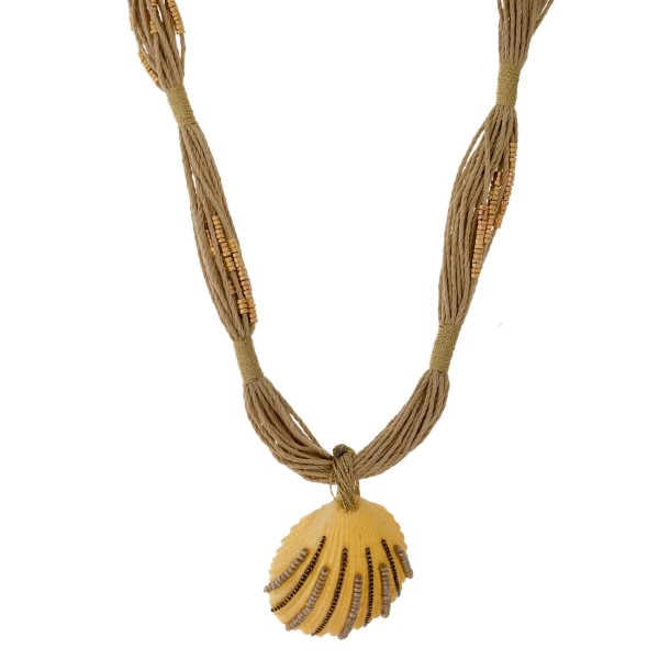 Braided cord necklace with gold tone accent beads and a shell pendant. Approximately 18" in length. 