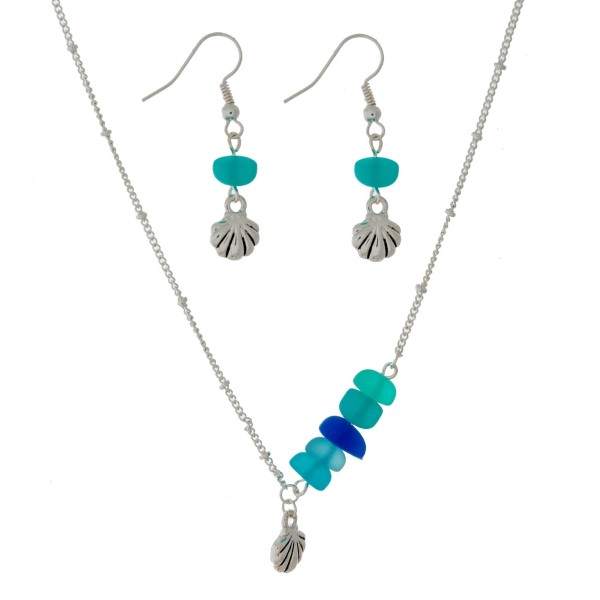 Silver tone necklace with sea glass beads and a beach themed charm. Approximately 16" in length. 