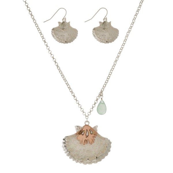 Silver tone necklace set with an iridescent glittered beach pendant and matching fishhook earrings. Approximately 18" in length. 