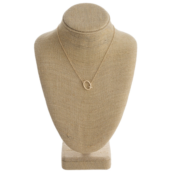 Gold metal necklace featuring the initial "Q". Approximately 16" in length.