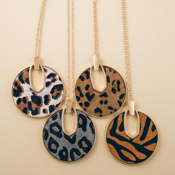 Cowhide leopard print encased disc pendant necklace.

- Pendant approximately 2.5" in diameter
- Approximately 34" in length overall