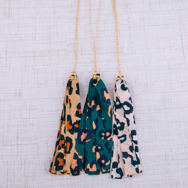 Long leopard print fabric tassel pendant necklace.

- Pendant approximately 5" L
- Approximately 40" in length overall 
- 3" extender