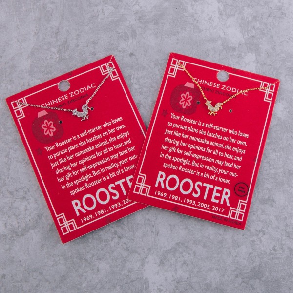 Gold dipped Chinese Zodiac Cubic Zirconia "Rooster" pendant necklace.

"Your Rooster is a self-starter who loves
 to pursue plans she hatches on her own.
 Just like her namesake animal, she enjoys 
 sharing her opinions for all to hear, and 
 her gift for self-expression may land her
 in the spotlight. But in reality, your spoken 
 Rooster is bit of a loner."
"1969, 1981, 1993, 2005, 2017" 

- Pendant approximately 1cm 
- Approximately 16" in length 