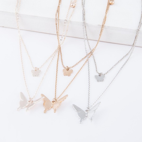 Short Double layered gold necklace with butterfly pendants. 
- Shorter chain measures approximately 14" L & longer chain measures approximately 17" L 
- Features a 3.5" extender 
