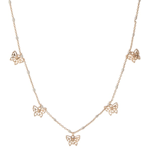 Short gold necklace featuring beaded accents and small filigree butterfly charms. 
- Approximately 16" L with 3" extender 

