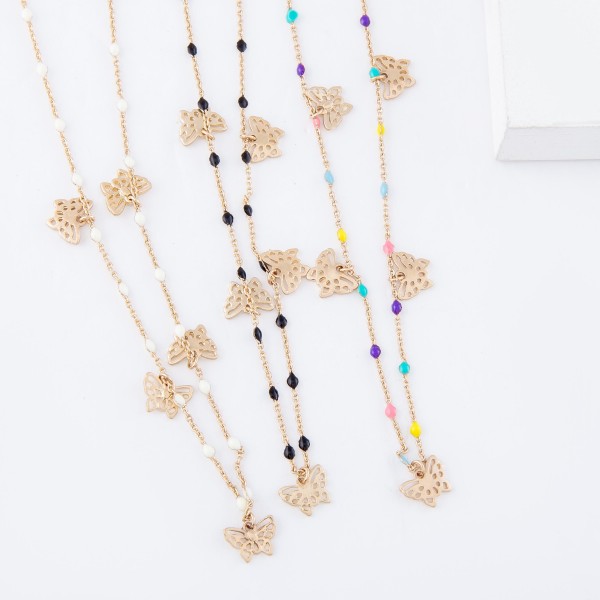Short gold necklace featuring beaded accents and small filigree butterfly charms. 
- Approximately 16" L with 3" extender 

