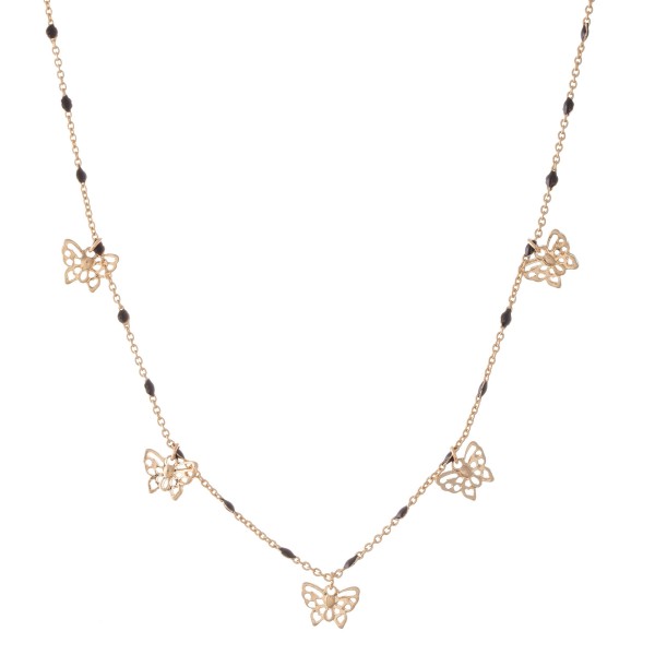 Short gold necklace featuring beaded accents and small filigree butterfly charms. 
- Approximately 16" L with 3" extender 

