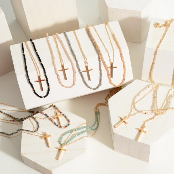 Layered Gold Necklace Featuring a Cross Pendant and Beaded Accents.
- Approximately 7.5" in Length
- Extender Approximately 3" in Length