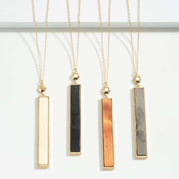 Long Gold Tone Necklace Featuring Painted Wood Rectangle Pendant 

- Approximately 36" Length
- 3" Extender