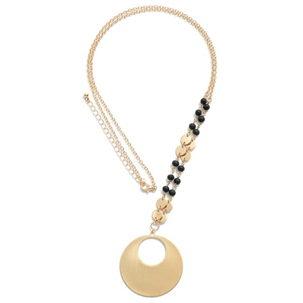 Long Chain necklace with flat gold tone beads, large circular pendant and Black colored wood beads. 

-Approximately 30 inch chain with 2inch extender 
-Pendant Diameter 1.5 inch
