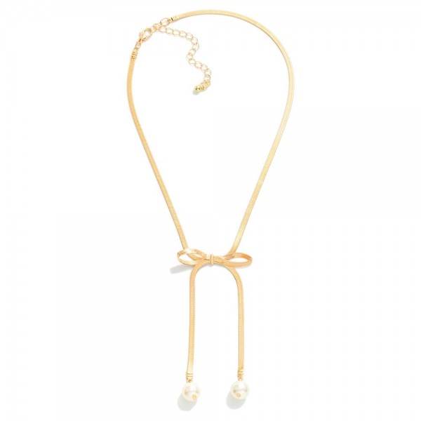 Metal Tone Herringbone Chain Link Bow Necklace With Pearl Details 

- Approximately 14" L
- Extender 3" L