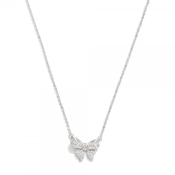 Metal Tone Dainty Chain Link Necklace Featuring Cubic Zirconia Studded Bow Station 

- Approximately 16" L
- Extender 2.5" L