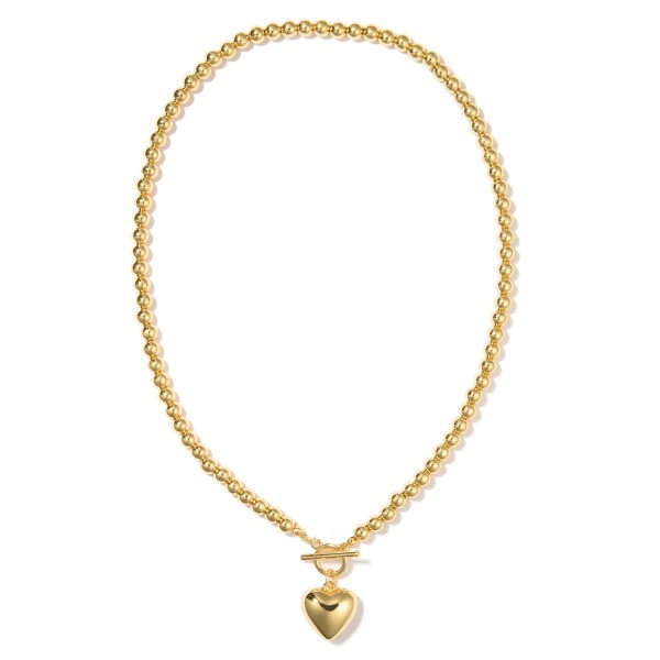 Metal Tone Beaded Necklace Featuring Puffy Heart & Toggle Clasp Pedant 

- Gold Dipped
- Approximately 18" L