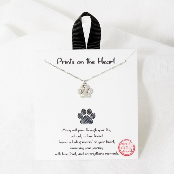 Dainty Chain Link Necklace Featuring Metal Tone Paw Print Pendant 				
					
- Approximately 16" L					
- Extender 2" L									
- Hypoallergenic Brass Base					
- 18K Gold Dipped					
- Card: "Many will pass through your life, but only a true friend leaves a lasting imprint on your heart, enriching your journey with love, trust, and unforgettable moments."					