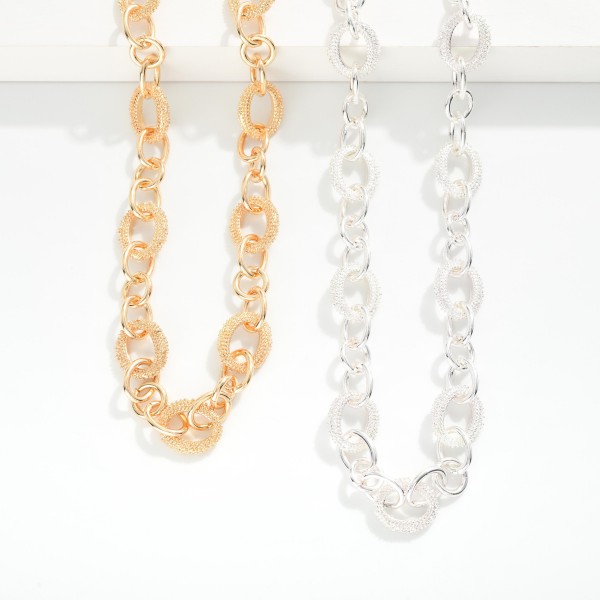 Chain Link Necklace Featuring Linked Textured Metal Oval 

- Approximately 16" L 
- Extender 3" L 