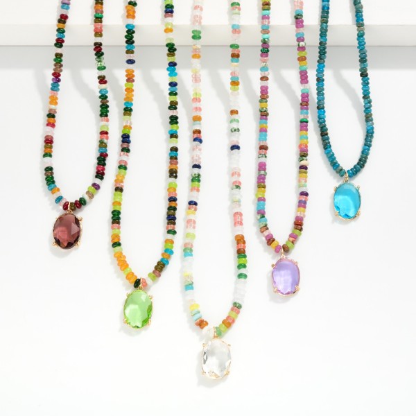 Stone Disk Beaded Necklace Featuring Glass Crystal Pendant

- Approximately 16" L 