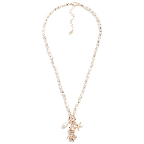 Pearl & Metal Tone Beaded Necklace Featuring Metal Tone Toggle Clasp With Fish Pendent 

- Approximately 20" L
- Extender 3" L

