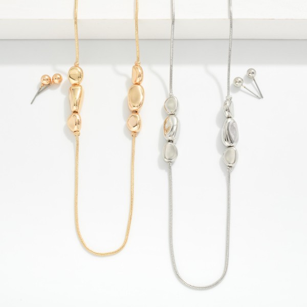 Snake Chain Necklace Featuring Metal Tone Pebble Bead Cluster Stations 
- Metal Tone Ball Studs Included 
- Approximately 16" L
- Extender 3" L