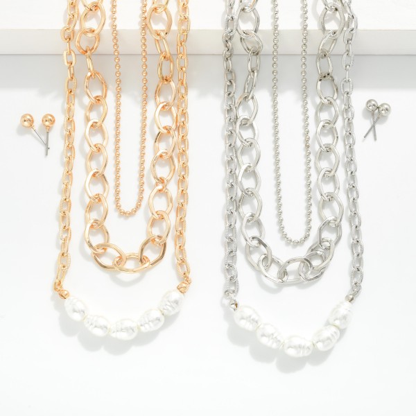 Layered Chain Link Necklace Featuring Pearl Details 
- Metal Tone Ball Studs Included 
- Approximately 14" L
- Extender 3" L