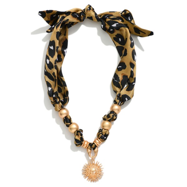 Leopard Bandana Charm Necklace Featuring Gold Tones, And Sun Pendant 

- Approximately 20" L

